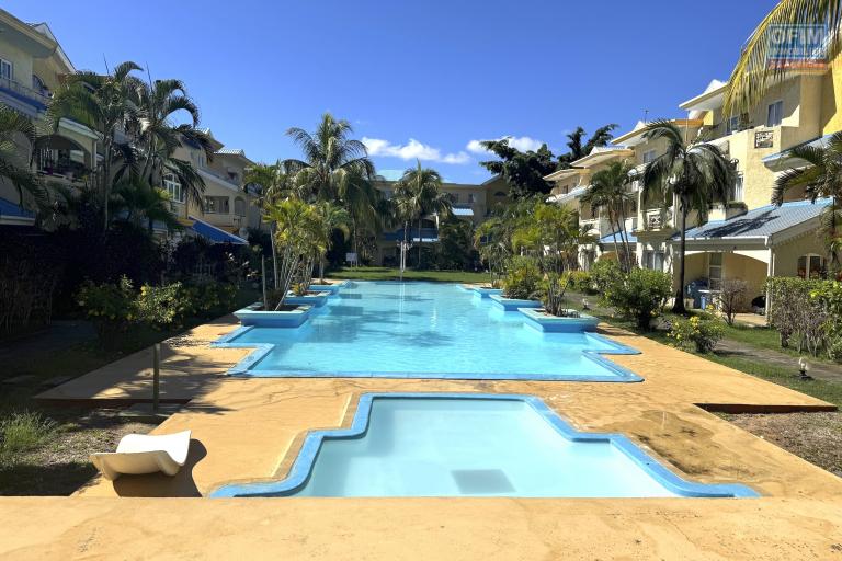 Flic en Flac for sale 3 bedroom triplex located in a beautiful secure residence with 2 large swimming pools and garage, close to amenities and the beach.