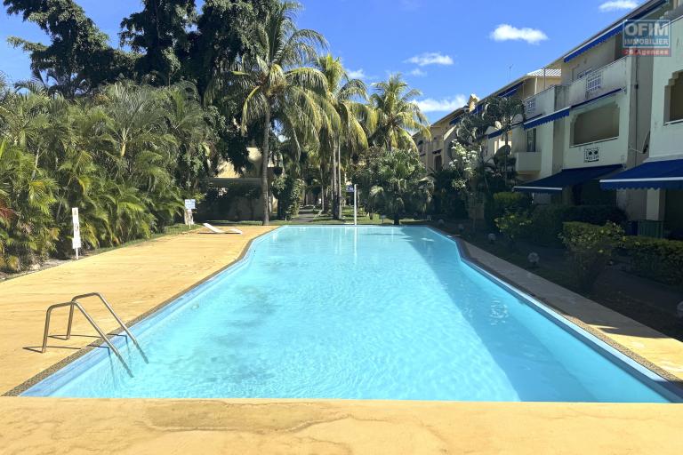 Flic en Flac for sale 3 bedroom triplex located in a beautiful secure residence with 2 large swimming pools and garage, close to amenities and the beach.