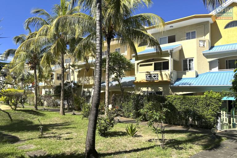 Flic en Flac for sale 3 bedroom triplex located in a beautiful secure residence with 2 large swimming pools and garage, close to amenities and the beach.