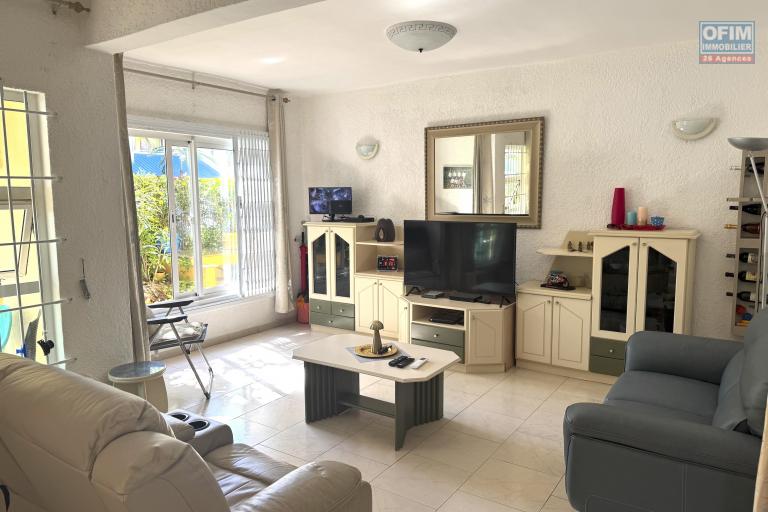 Flic en Flac for sale 3 bedroom triplex located in a beautiful secure residence with 2 large swimming pools and garage, close to amenities and the beach.