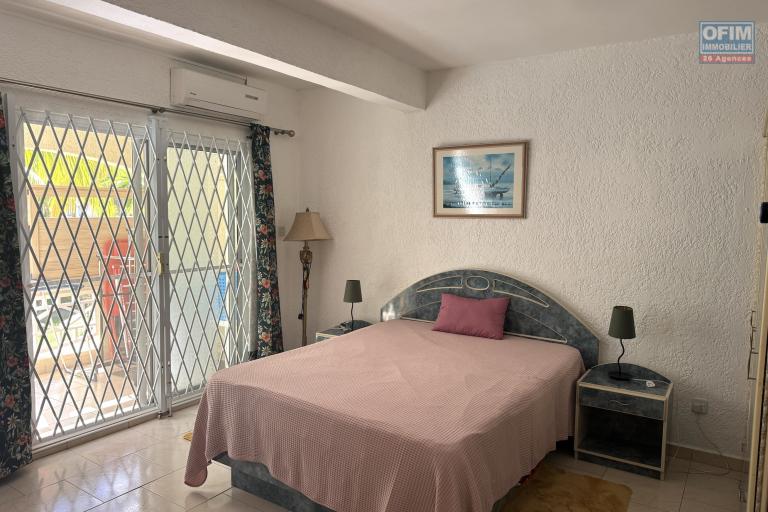 Flic en Flac for sale 3 bedroom triplex located in a beautiful secure residence with 2 large swimming pools and garage, close to amenities and the beach.